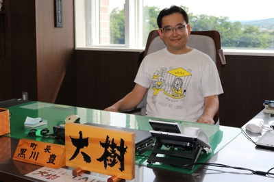 町長の椅子に座っている楾大樹さんの写真