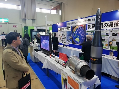 ビジネスEXPOにおけるスペース内にて、展示されたZEROのモックアップを眺める来場者の写真