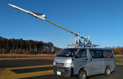 オオワシ2号の縮小機体の飛行実証のために車の上に置いている写真