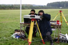探査機と天体表面との距離を計る装置で測定をしている人たちの写真
